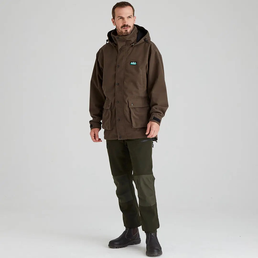 Man in brown hooded jacket and green pants wearing Ridgeline Torrent III jacket