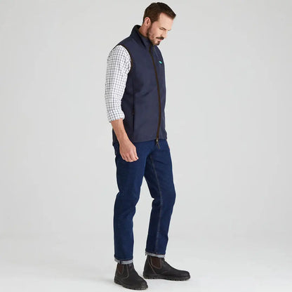 Man wearing Ridgeline Monarch Gilet navy vest jeans and boots outdoor style