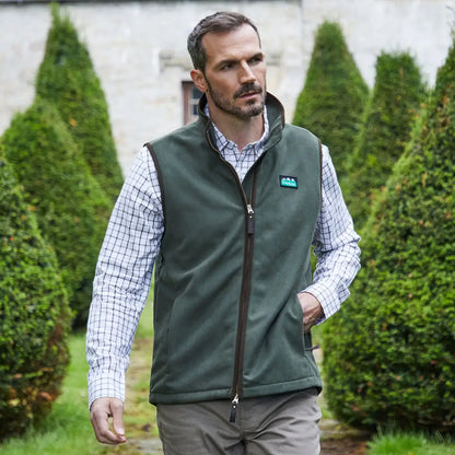 Man wearing an olive green Ridgeline Monarch Gilet for outdoor adventures