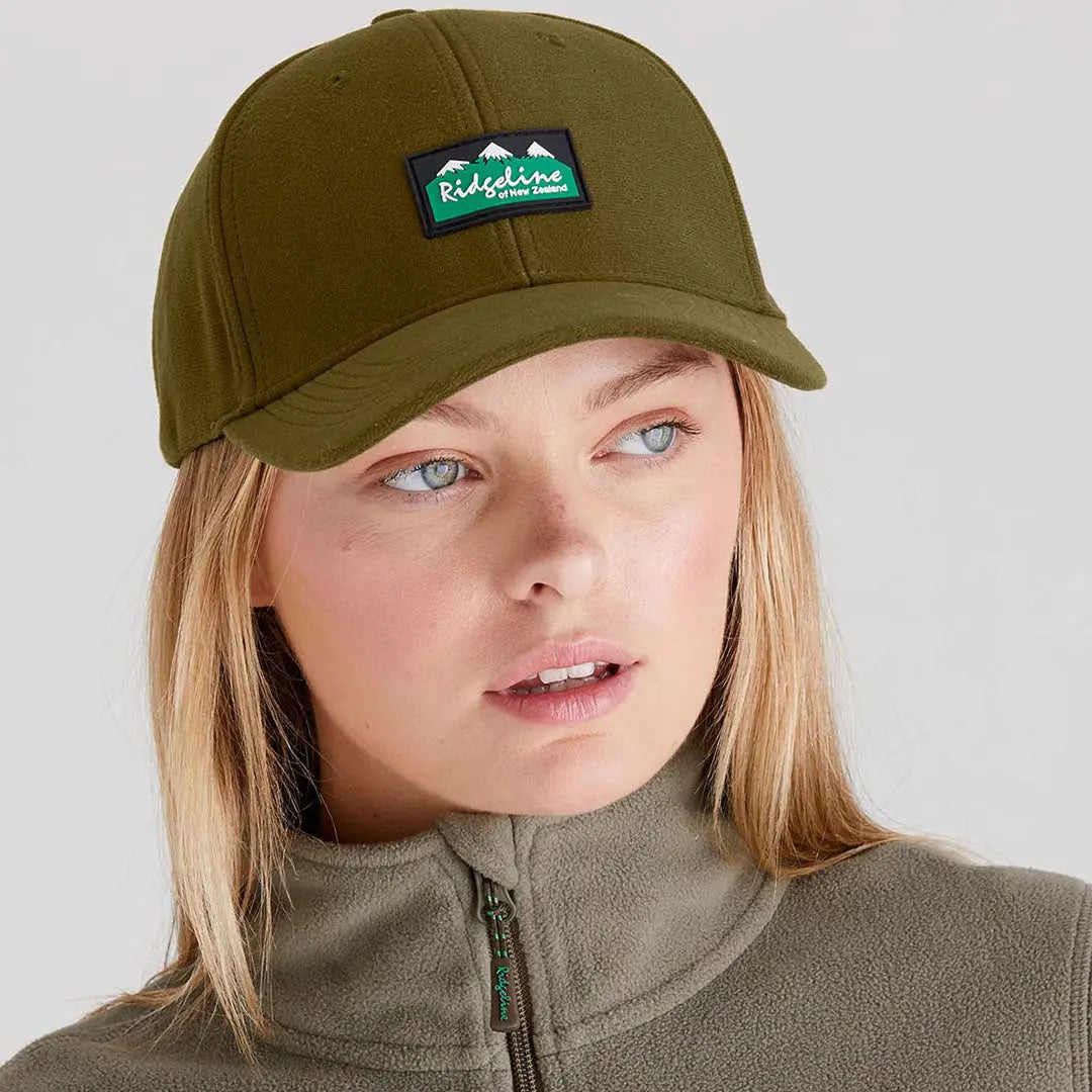Woman wearing an olive green Ridgeline Monsoon Classic Cap with patch