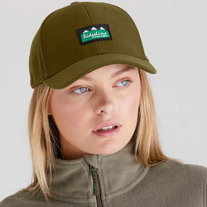 Woman wearing an olive green Ridgeline Monsoon Classic Cap with patch