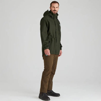 Man in green hooded parka and brown pants wearing Ridgeline Monsoon Light Jacket