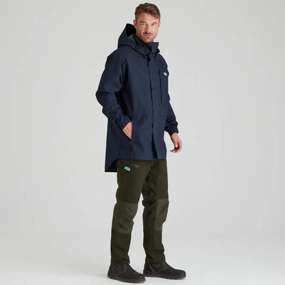 Man wearing Ridgeline Monsoon Light Jacket in navy blue with green pants