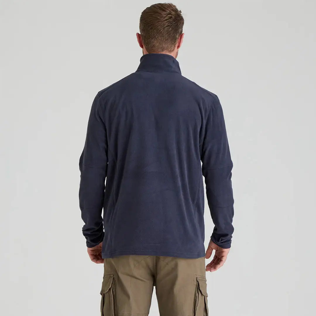 Man wearing Ridgeline Narvik Fleece navy jacket and khaki cargo pants, highly functional polyester fleece