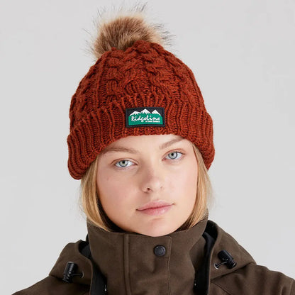 Rust-colored Nordic Fleck Bobble Hat with faux fur pom-pom and Ridgeline patch