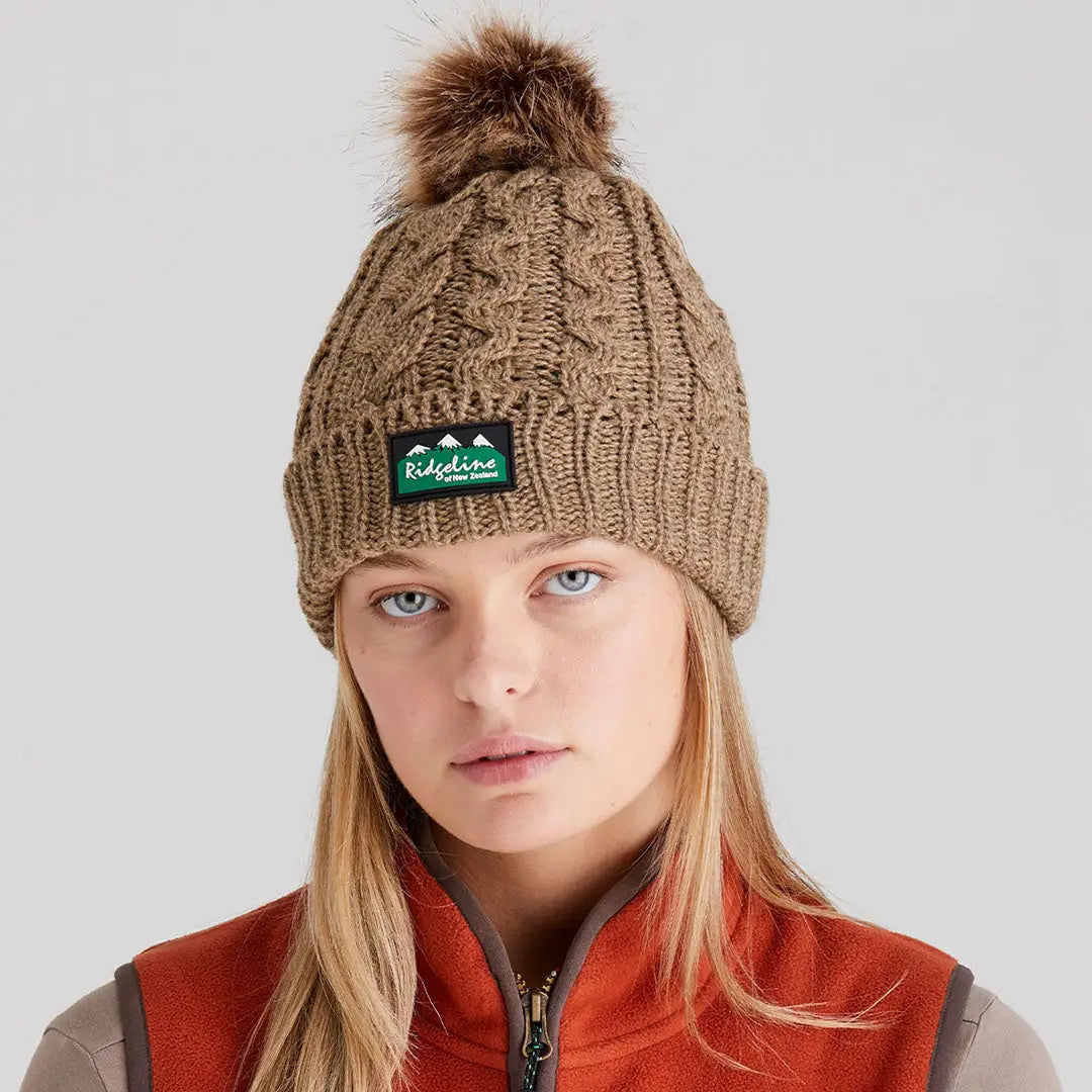 Woman wearing Ridgeline Nordic Fleck Bobble Hat with faux fur pom-pom in cozy style