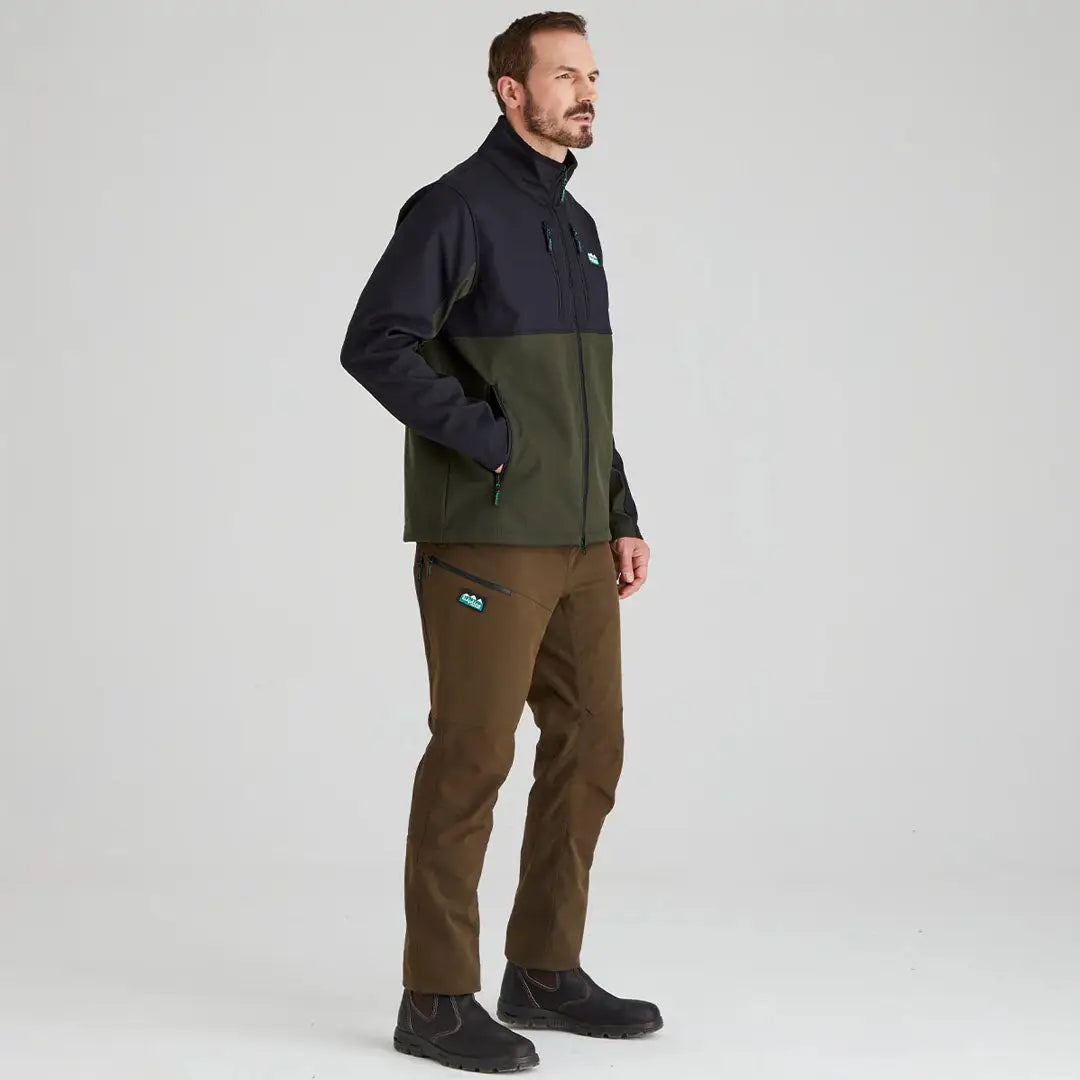 Man in Ridgeline Ranger Jacket and brown pants showcasing durable softshell style