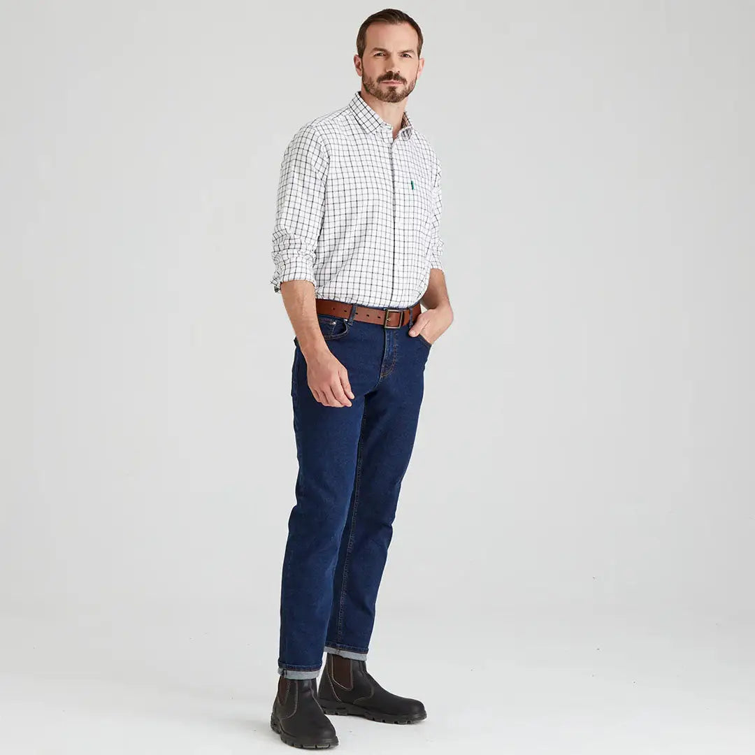 Man wearing Ridgeline Sedgebrook Shirt in checkered pattern and jeans