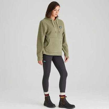 Woman wearing a Ridgeline Womens Ballistic Hoodie with green hoodie and black leggings