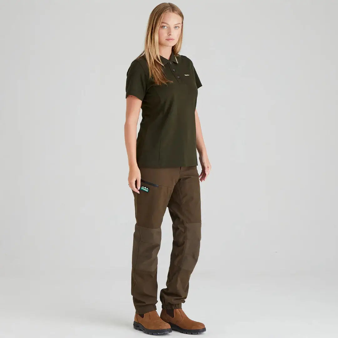 Ridgeline Womens Kilworth Polo Shirt styled with a woman in olive green polo and brown pants