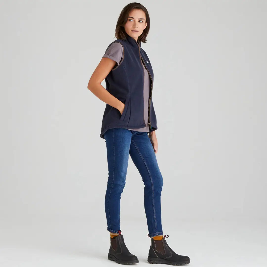 Woman in Ridgeline Womens Kodiak Gilet with navy vest, jeans, and boots