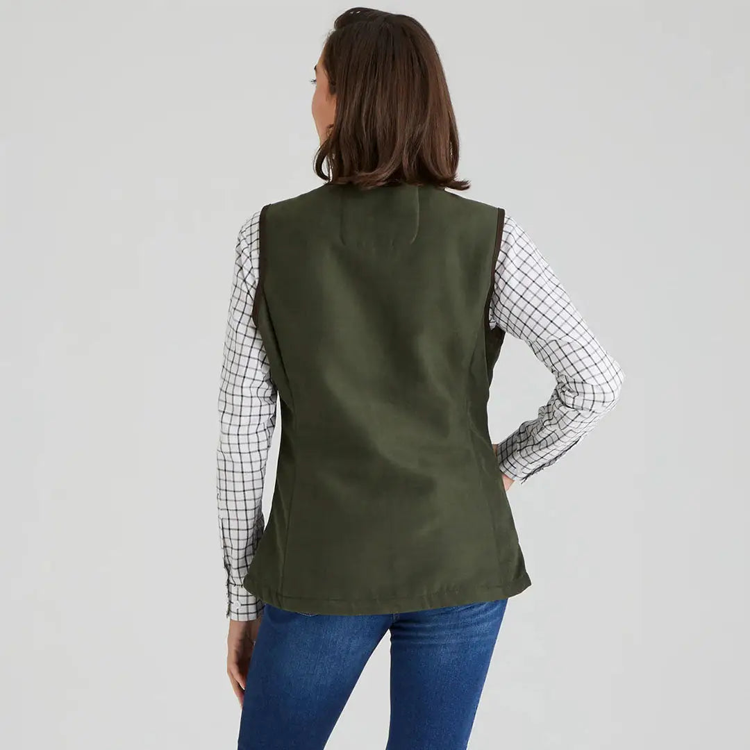 Woman wearing a green Ridgeline Women’s Monarch Gilet for outdoor adventures