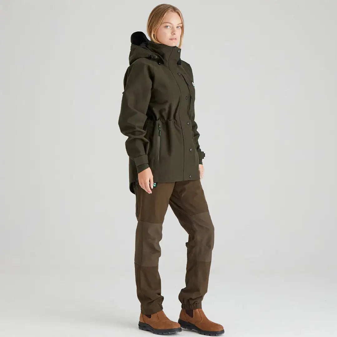 Woman in green Ridgeline Womens Monsoon Classic Jacket going for a hike outdoors