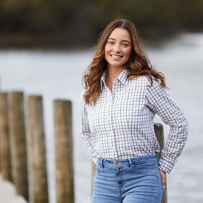 Woman in a checkered shirt and jeans wearing Ridgeline Womens Sedgebrook Shirt