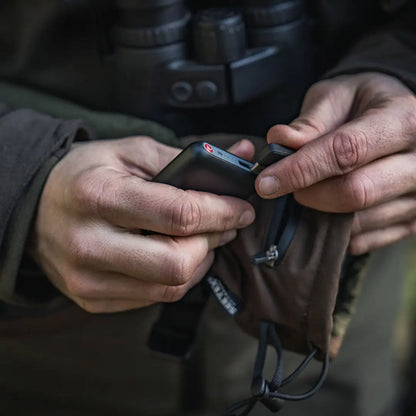 Person holding a black power bank with Seeland Celsius Heat Gloves for heat on the go