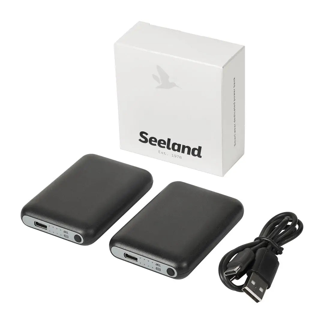 Seeland Celsius Heat Sock with two black power banks, charging cable, and white box