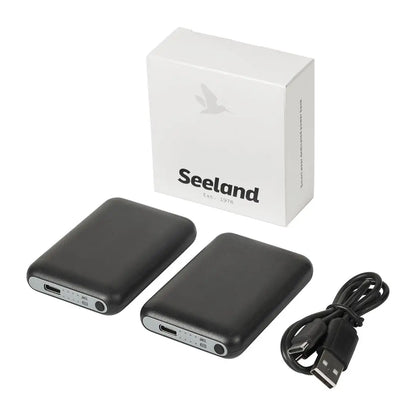 Seeland Celsius Heat Sock with two black power banks, charging cable, and white box