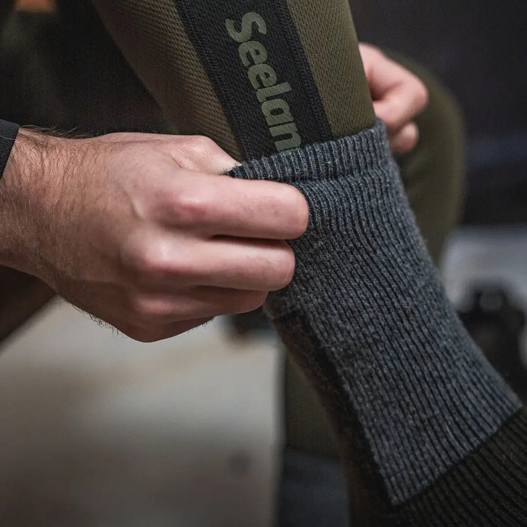 Gray wool field thermo sock being pulled up, comfortable Seeland Field Thermo Socks