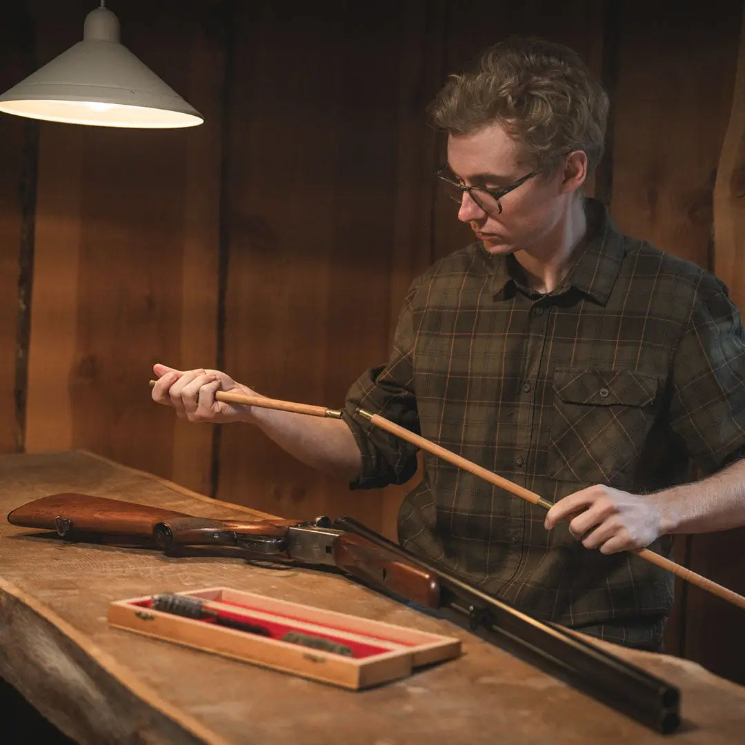 Man cleaning a shotgun in Seeland Glen Flannel Shirt, perfect glen flannel shirt for outdoors