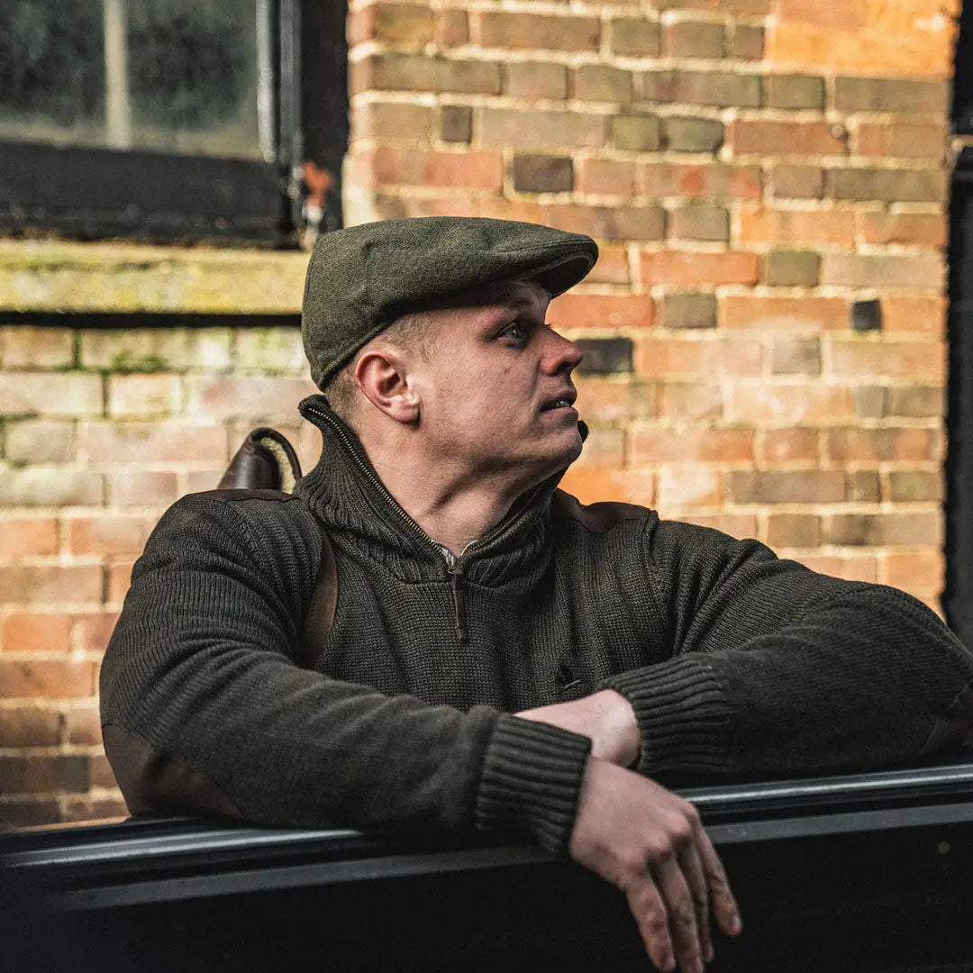 Man in green cap and sweater, showcasing Seeland Haze Windbreaker Knit Jumper with Seetex windbreaker lining