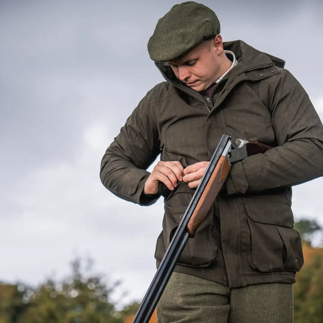 Man in hunting attire with shotgun wearing Seeland Highpoint Jacket for country hunting