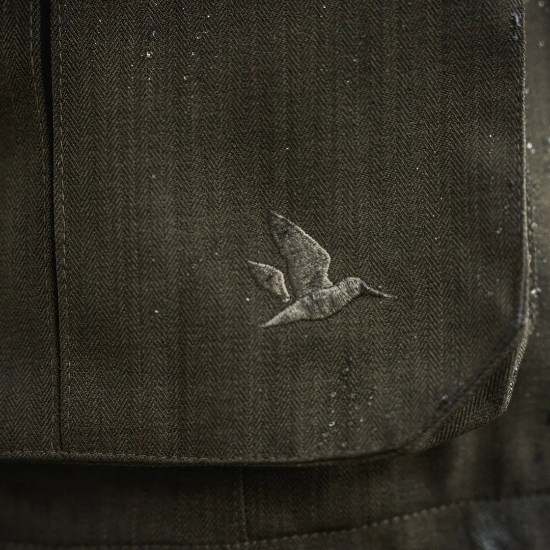 Dark herringbone fabric with bird emblem on Seeland Highpoint Jacket, perfect for country hunting gear