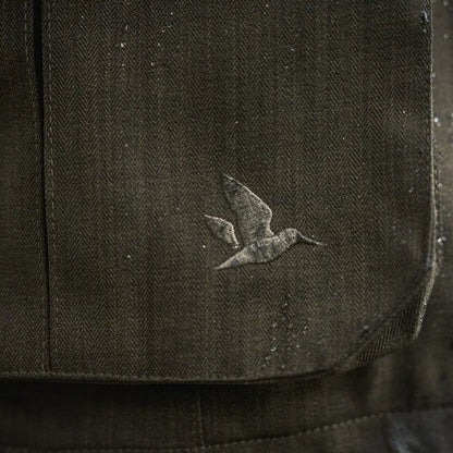 Dark herringbone fabric with bird emblem on Seeland Highpoint Jacket, perfect for country hunting gear
