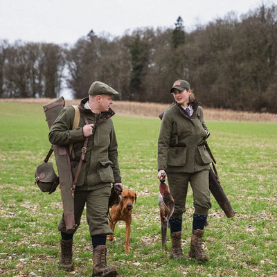 Two hunters in a field with a dog, wearing the Seeland Hillside Jacket