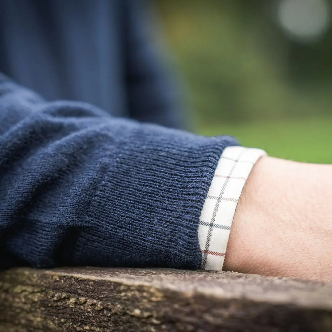 Navy pine V-neck sweater with plaid cuff, perfect for country clothing and hunting trips
