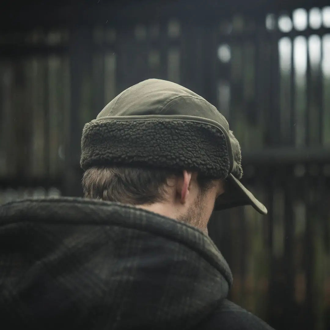 Olive green teddy fold-down cap, perfect trapper hat for outdoor adventures