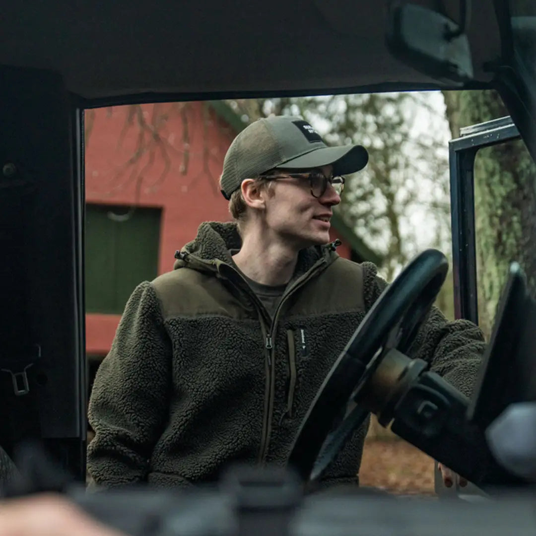 Man in a vehicle wearing Seeland Thaw Fleece Jacket, perfect for staying warm with a fleece jacket