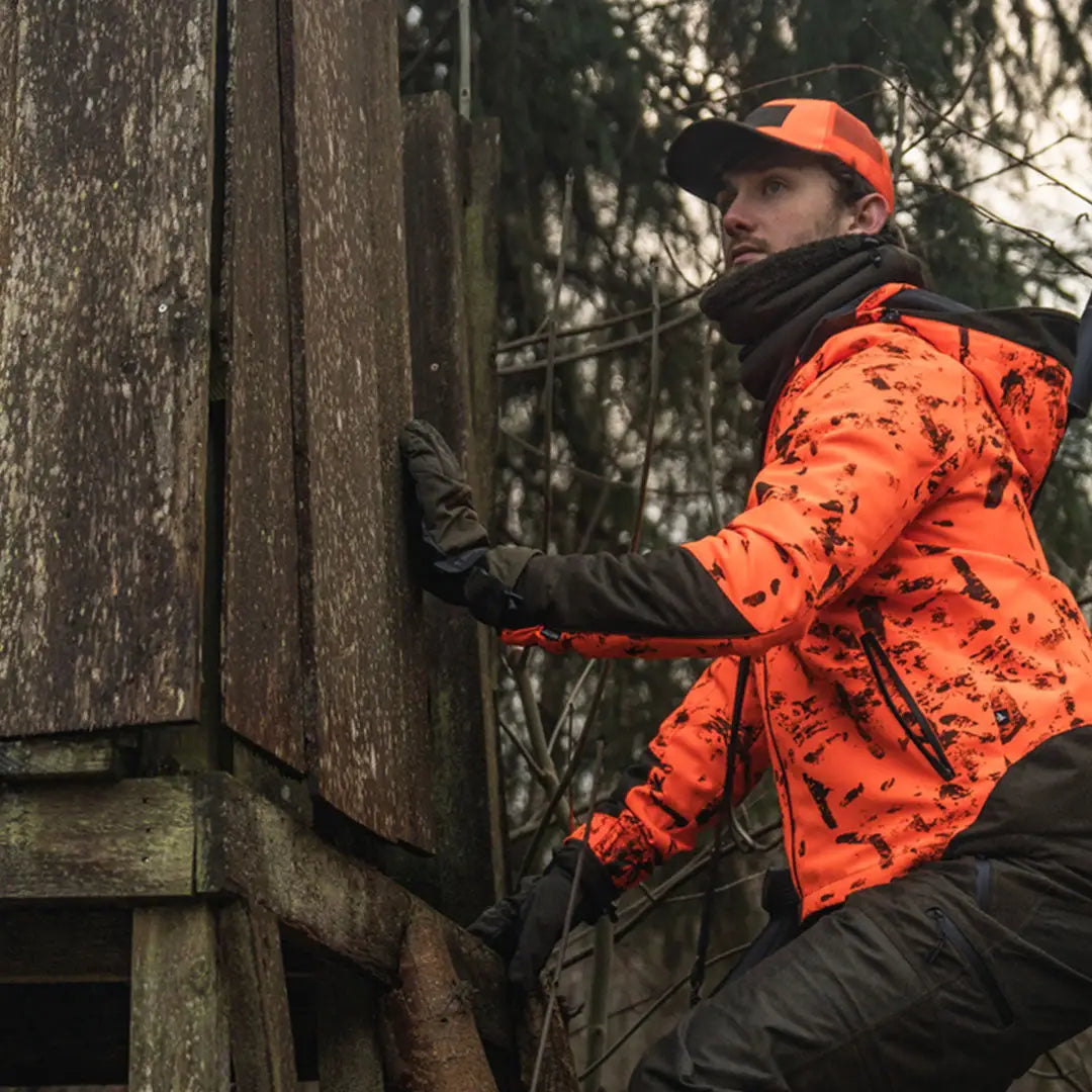 Hunter climbing wooden deer stand wearing Seeland Trigger Fold-Back Gloves for hunting and outdoors
