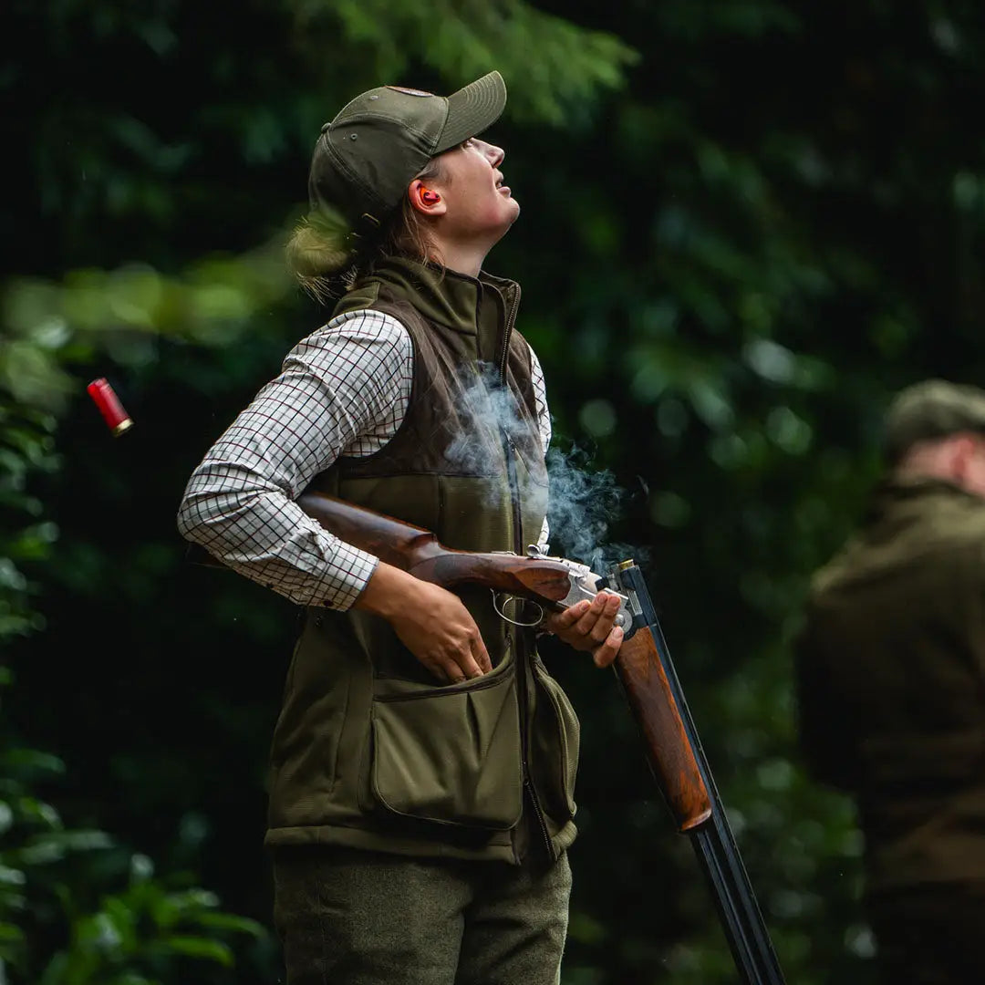 Woman shooting a shotgun in Seeland Wenlock Faye Ladies Waistcoat, perfect for country clothing
