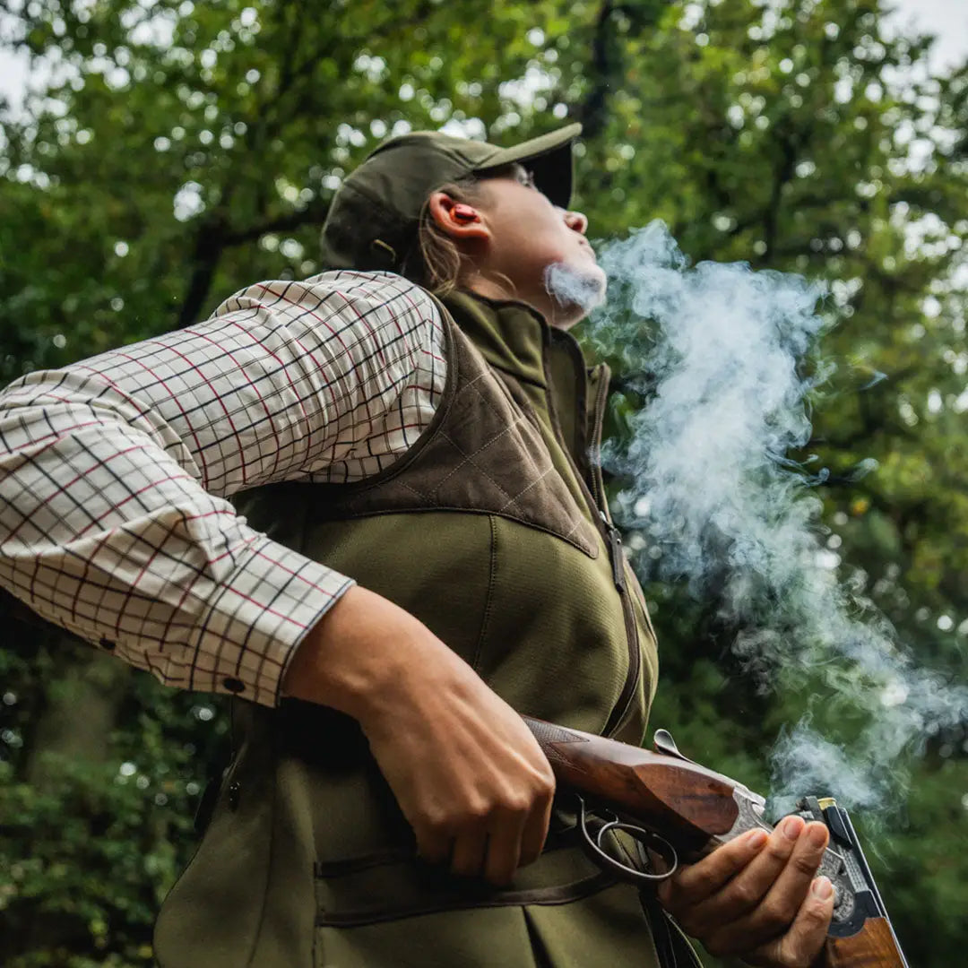 Woman holding a shotgun in Seeland Wenlock Faye Ladies Waistcoat for country clothing