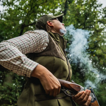 Woman holding a shotgun in Seeland Wenlock Faye Ladies Waistcoat for country clothing