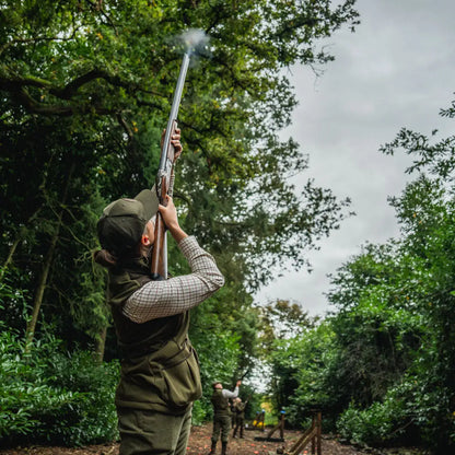 Person firing shotgun while wearing Seeland Wenlock Faye Ladies Waistcoat for hunting