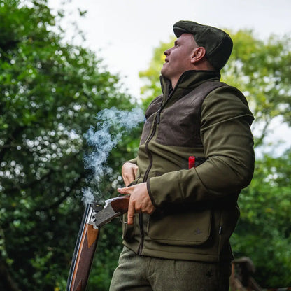 Hunter in Seeland Wenlock Mens Jacket with smoking shotgun, perfect for outdoor hunting gear
