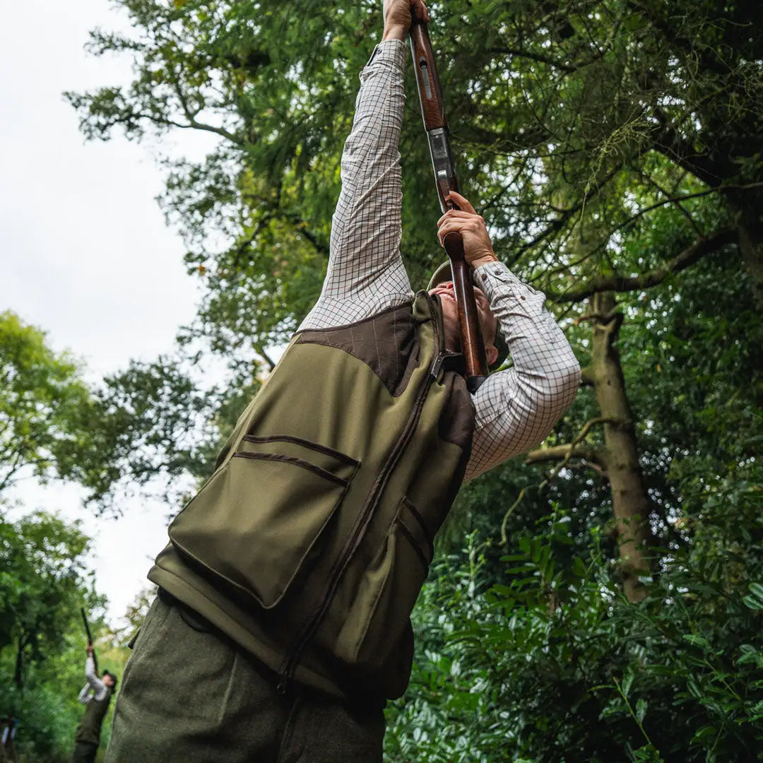 Hunter aiming shotgun while wearing Seeland Wenlock Mens Waistcoat for country clothing