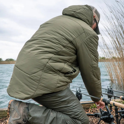 Person fishing in a lake wearing snugpak tomahawk cold weather insulated jacket