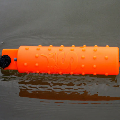 Bright orange Sporting Saint Water Dummy floating in water for fun dog playtime