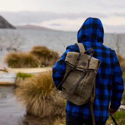 Person in blue plaid Swanndri Arrowtown country clothing with green backpack and fishing rod