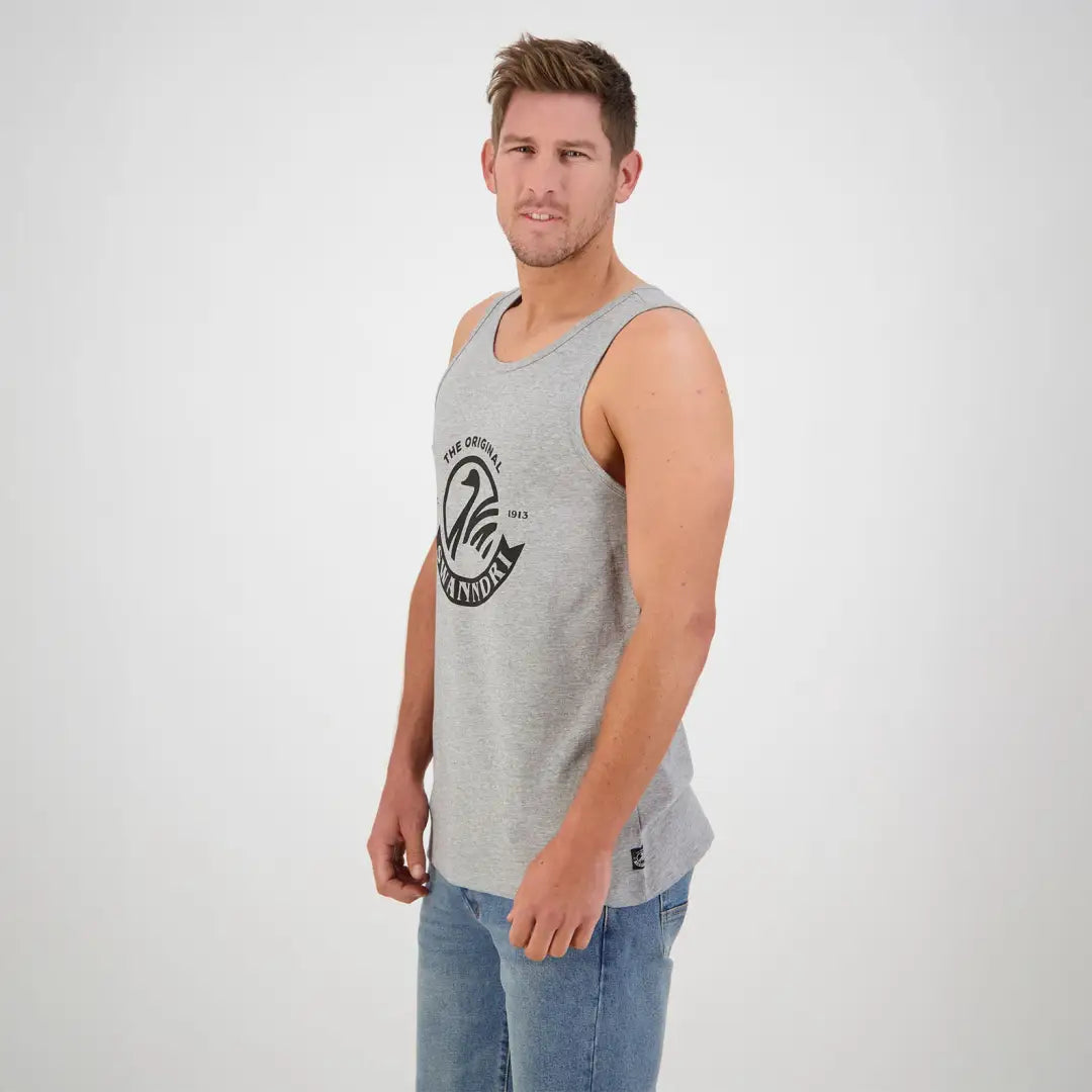 Man in a light gray tank top featuring a circular logo from Swanndri Classic V2 Printed Singlet
