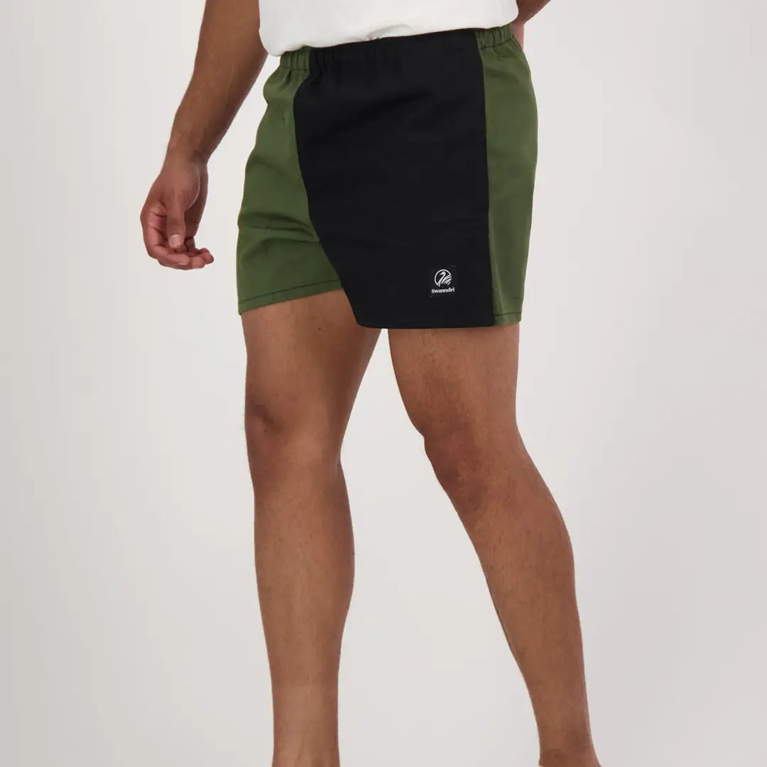 Two-tone harlequin rugby shorts with green side panel and black center panel