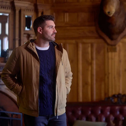 Man in tan jacket and blue cable knit sweater wearing Swanndri Doncaster Mens cable knit crew