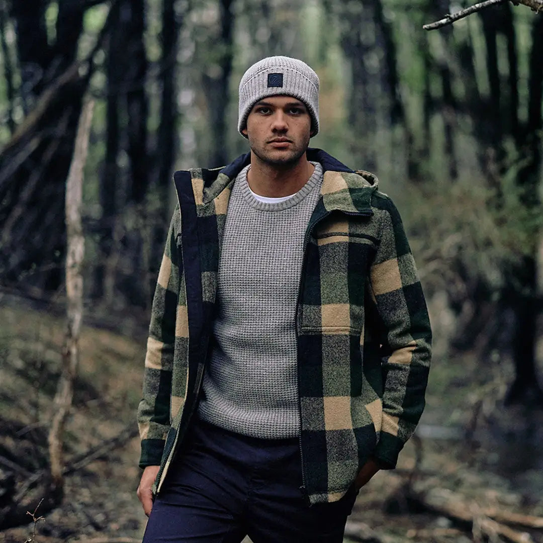 Man wearing Swanndri Hudson Wool Hoodie with grey beanie and plaid jacket outdoors
