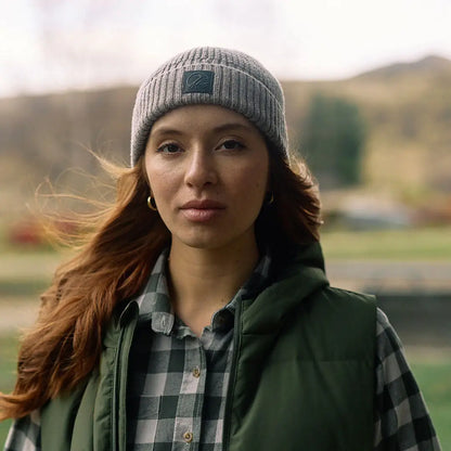 Woman in gray knit beanie and plaid shirt wearing Swanndri Newton Beanie outdoors