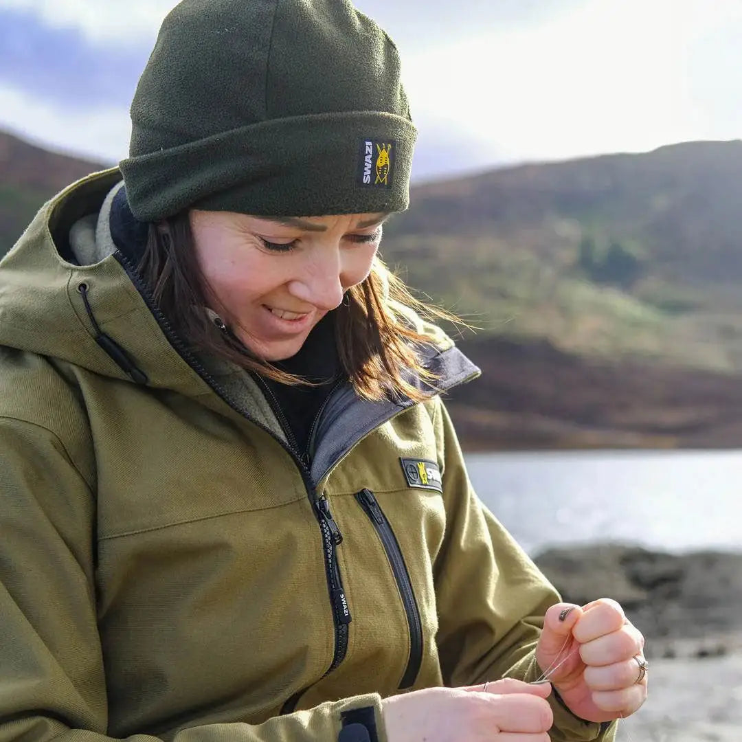 Woman in Swazi Artemis Womens Jacket, outdoor hunting jacket, tying fishing line