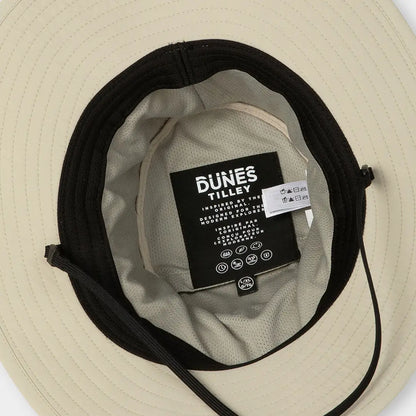 Wide-brimmed beige Tilley Dunes Drifter Hat with black band and interior tag