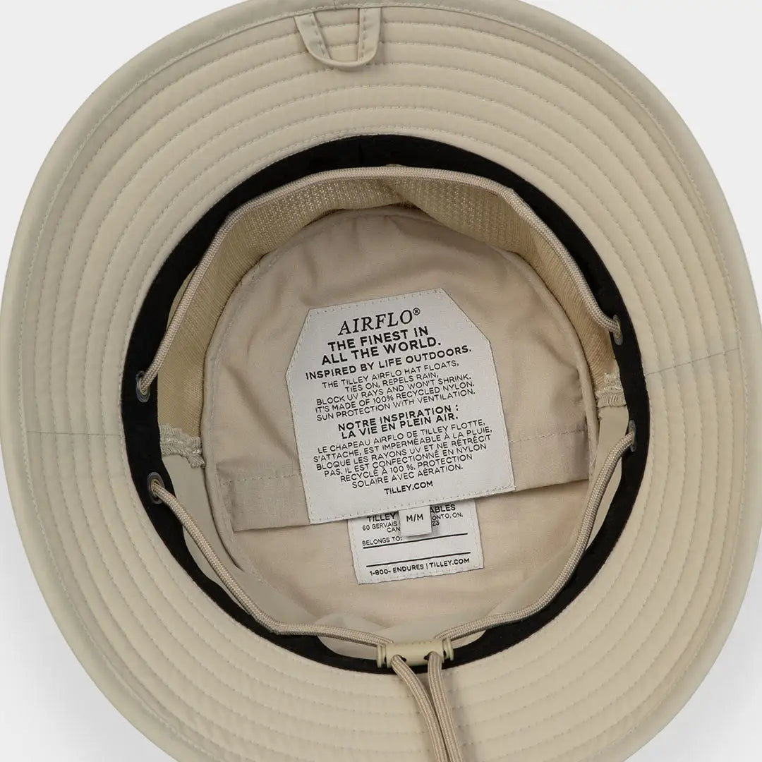 Beige Tilley LTM1 Airflo Bucket with iconic T1 silhouette and interior label visible