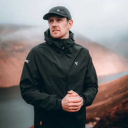 Man in dark green Venture Ultralite Waterproof Running Cap enjoying outdoor adventures